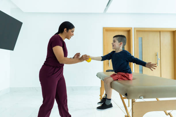 istock Therapist leads young boy in coordination exercises 2010880247