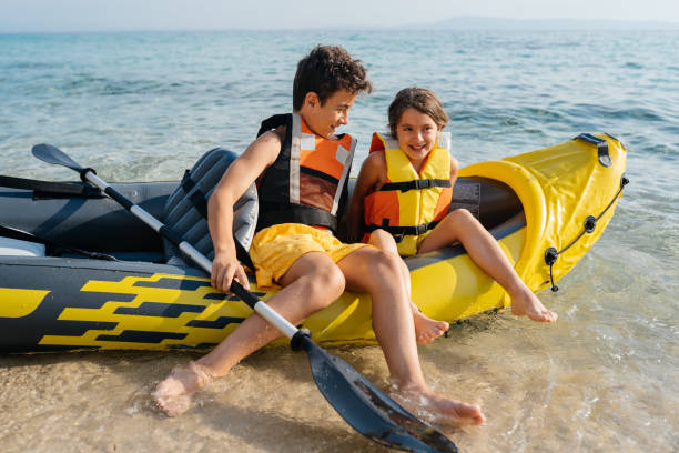 istock Teenagers having fun kayaking with inflatable raft on their summer vacation 2010885033