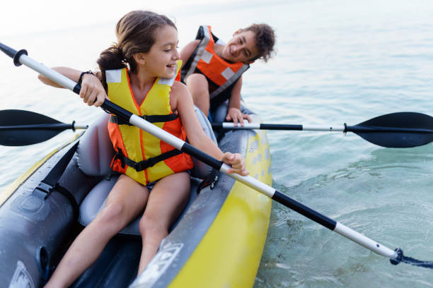 istock Teenagers having fun kayaking with inflatable raft on their summer vacation 2010885589