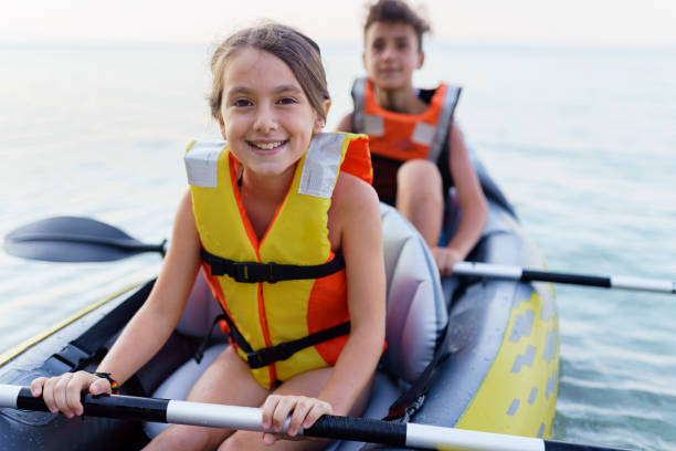 istock Teenagers having fun kayaking with inflatable raft on their summer vacation 2010885620