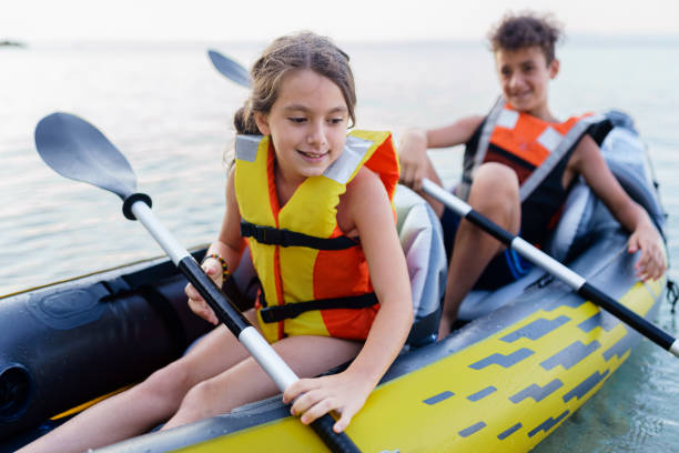 istock Teenagers having fun kayaking with inflatable raft on their summer vacation 2010885633