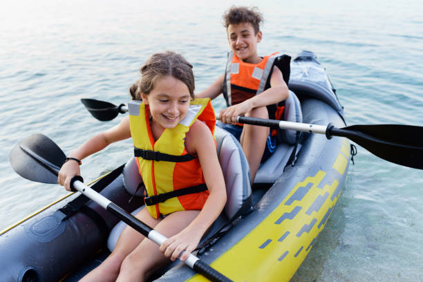 istock Teenagers having fun kayaking with inflatable raft on their summer vacation 2010885656