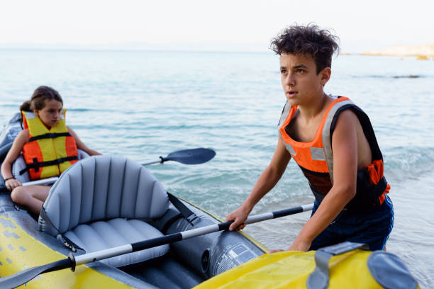 istock Teenagers having fun kayaking with inflatable raft on their summer vacation 2010885702