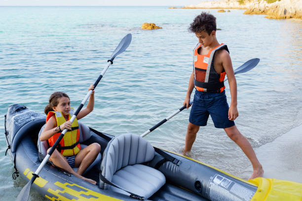 istock Teenagers having fun kayaking with inflatable raft on their summer vacation 2010885738