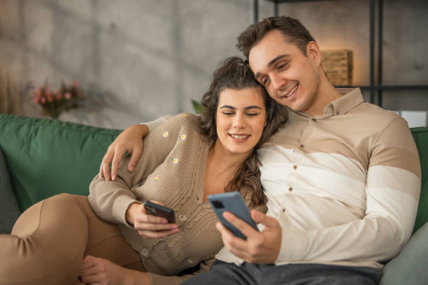 istock A couple relaxing at home and using technology  a mobile phones 2010885761