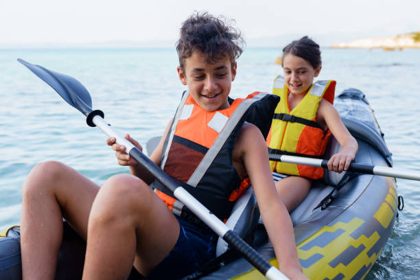 istock Teenagers having fun kayaking with inflatable raft on their summer vacation 2010885786