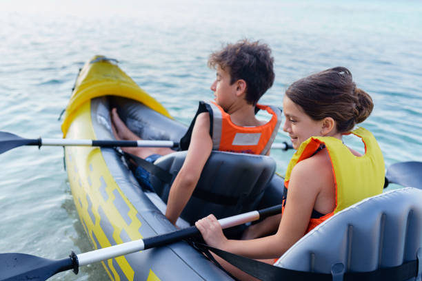 istock Teenagers having fun kayaking with inflatable raft on their summer vacation 2010885811