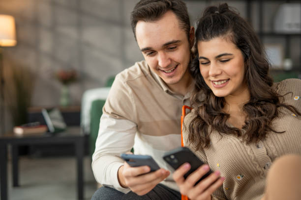 istock A couple relaxing at home and using technology  a mobile phones 2010885962