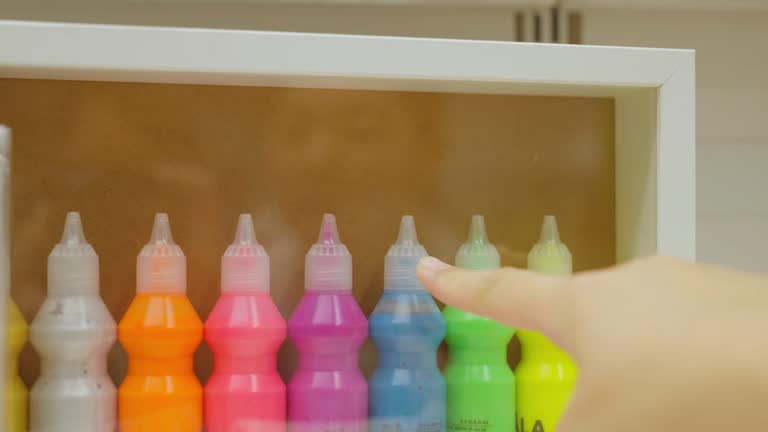 Asian woman's hands choosing colors to use in art