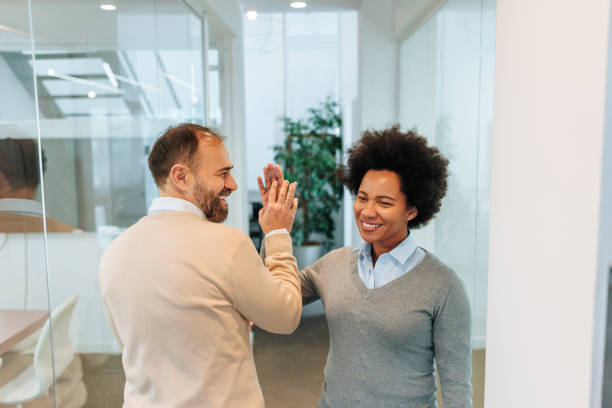 istock Employees doing the high five in the office 2010902719