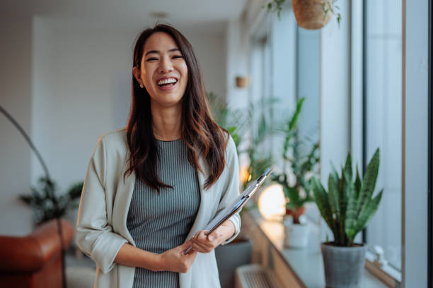 istock Asian woman posing and smiling at work 2010920132