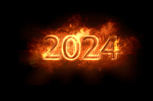 year 2024 - an inscription made of fire and fireworks illuminating the darkness