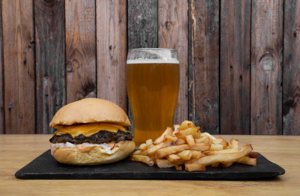 istock Classic cheeseburger with fries and a beer 2010929160