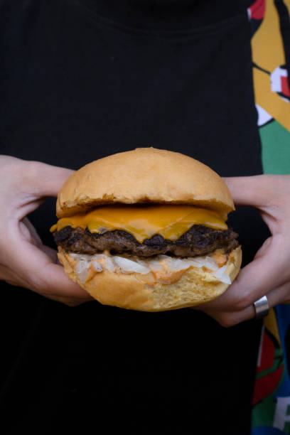 istock Woman holding a delicious cheeseburger 2010930195