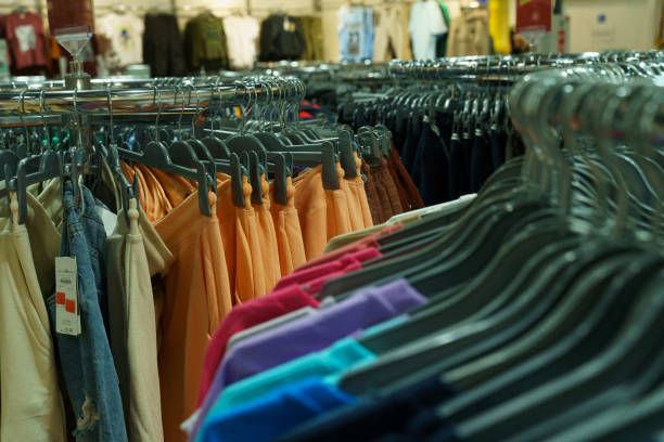 istock Modern plain clothes - trousers and sweaters, on a hanger in the store 2010934867