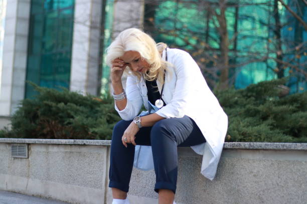 istock Mature woman doctor tired on pause 2010936941