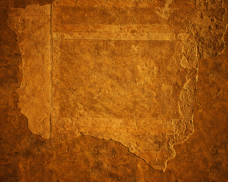 Ancient brown plastered wall with weathered fresco.