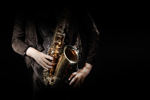 Saxophone player jazz musician saxophonist. Woman hands with sax jazz music instrument