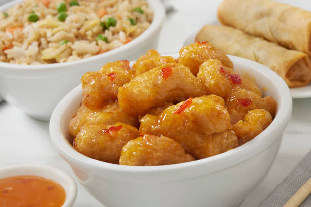 Cropped image of woman serving chicken nuggets for herself at birthday party