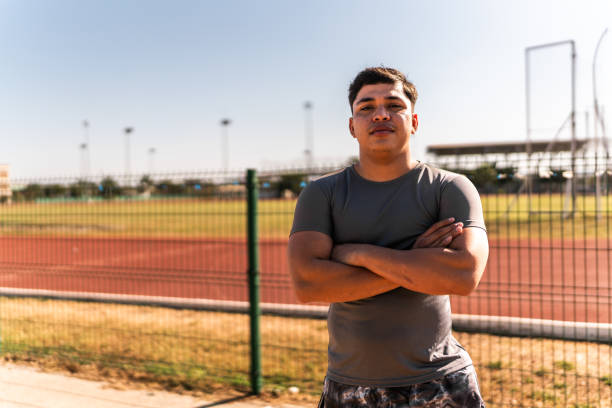 Young athlete man on track and field stadium