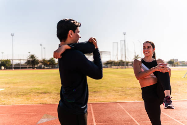 istock Athletes talking and stretching on track and field stadium 2010996264