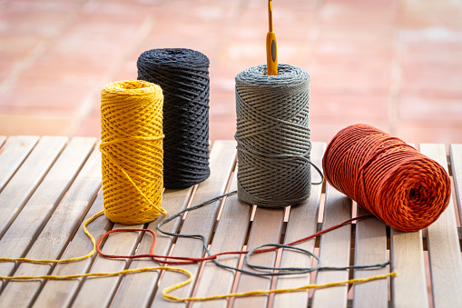 Spools of colorful cotton thread on wooden table