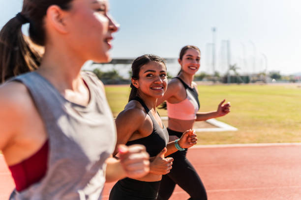 istock Athlete women training together on track and field stadium 2011012005