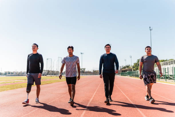 Athletes walking on sports track - Including athlete with disabilities