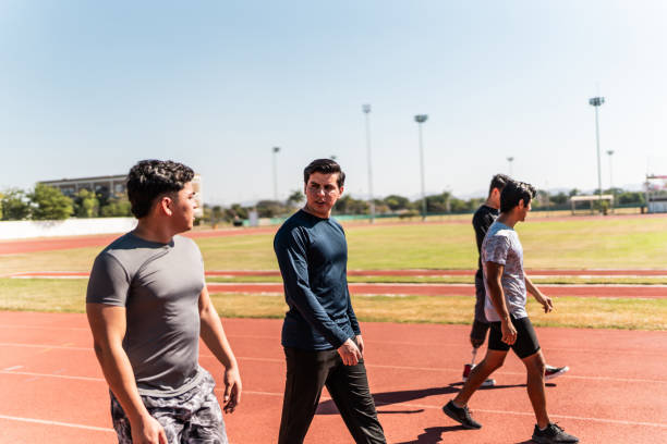 istock Athletes talking and walking on sports track 2011035252