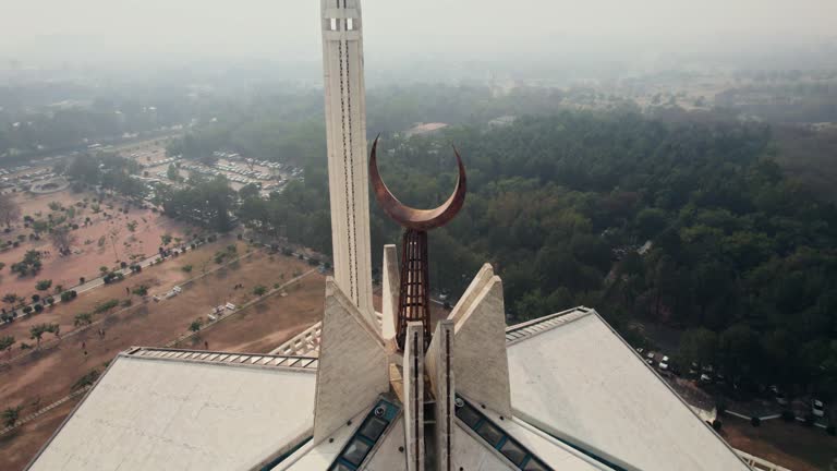 Close-up drone tilt shot of the high Faisal Mosque in Islamabad at daylight.