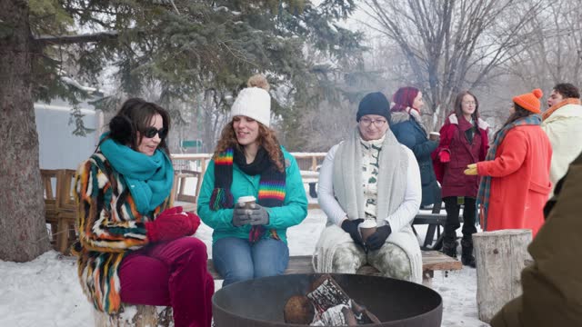 Fireside Comfort: Gimbal Shot Captures Trans Women joining by the Fire