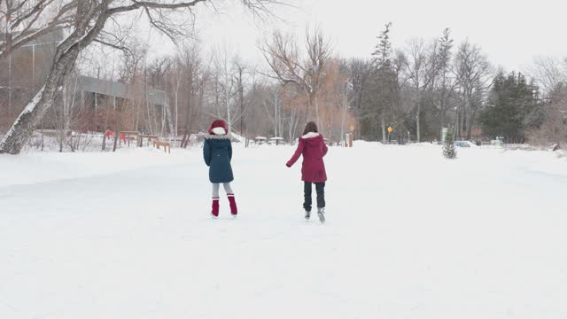 Mentor and trans teen skating on the ice together
