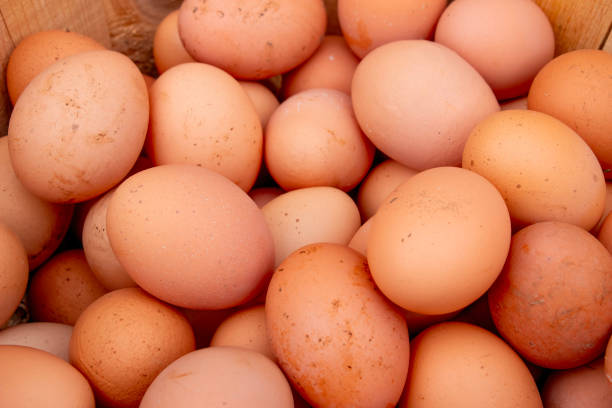 istock Pile of raw brown chicken eggs, top view 2011049036