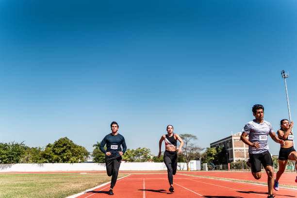 Athletes running on track and field stadium