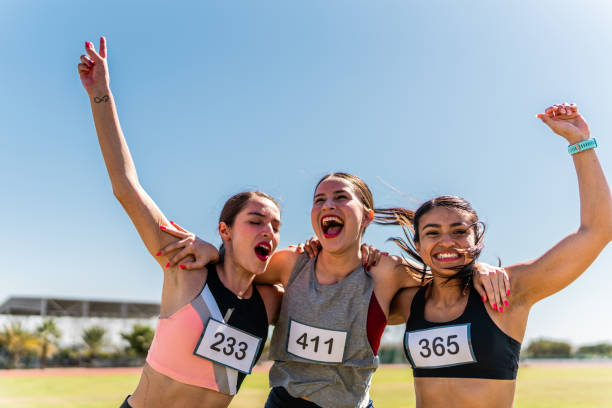 athlete women celebrating after race at sports track - track and field 30s adult athlete photos et images de collection