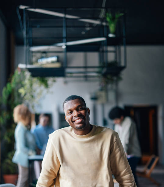 istock Smiling Man in Casual Wear Inside a Modern Workspace 2011075271