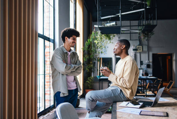 Two Colleagues Sharing a Light Moment in a Modern Office