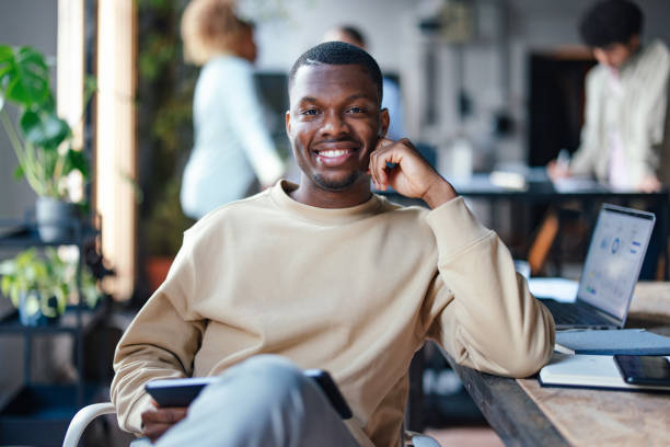 Confident Young Businessman Smiling in Modern Office