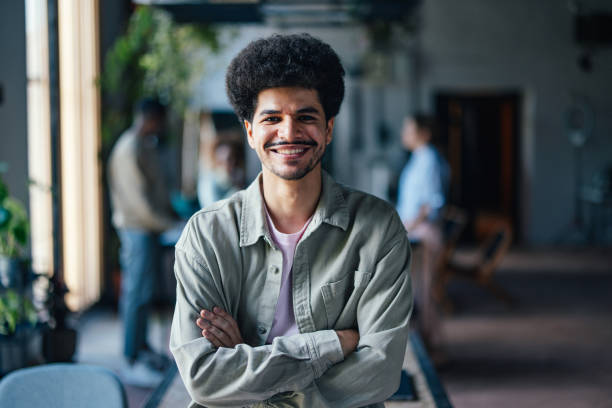 istock Confident Young Man Smiling at Camera in Casual Setting 2011075831