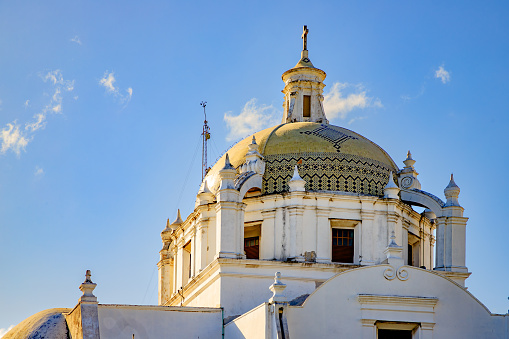 The Dome of the Cathedral of Veracruz is covered in poblana talaver and is a characteristic feature of the architecture of this historic building in the center of the Port of Veracruz. It is illuminated by the rays of morning light and the cross stands out at the highest part.