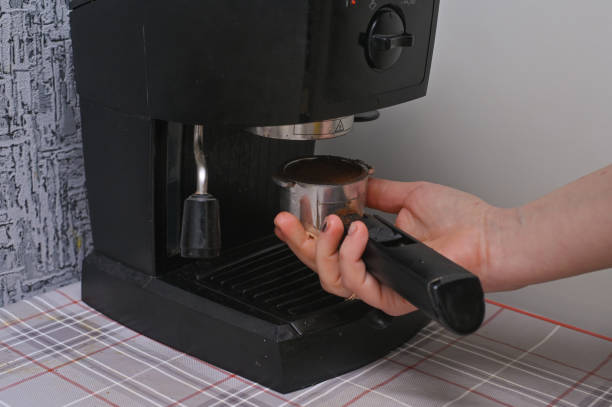 istock a woman makes coffee on a home coffee maker 2011087910