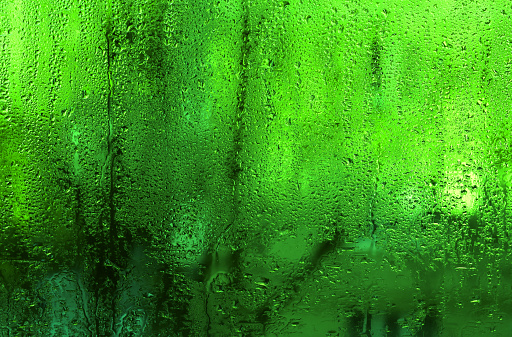 The background is wet glass. green texture