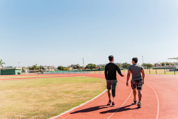 Athletes with artificial leg walking on sports track