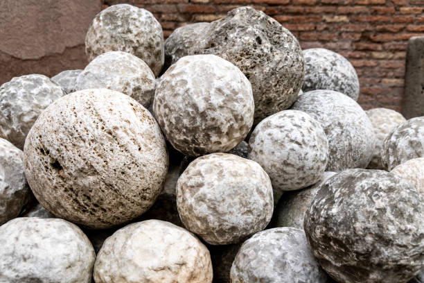 Cluster of old stone cannonballs, remnants of historical artillery