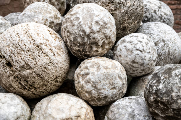 Cluster of old stone cannonballs, remnants of historical artillery