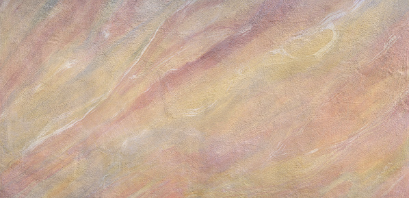 Painted pastel-colored pattern on a wall with grainy plaster