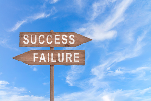 Man jump across text failure to success over cliff on sunset background. Failure Success concept. Business strategy.