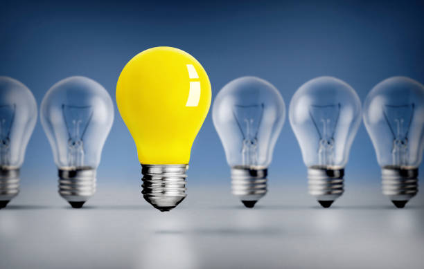 istock Yellow Lightbulb outstanding among lightbulbs on Blue background 2011196234