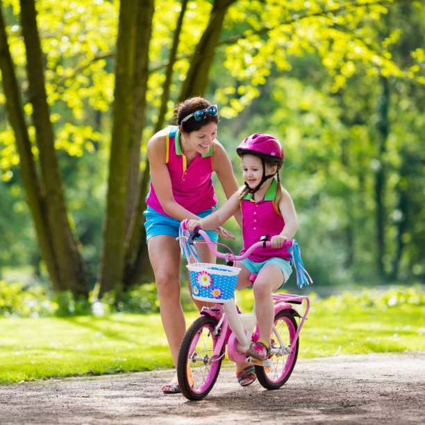 istock Mother teaching child to ride a bike 2011217468