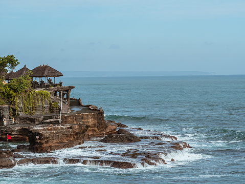 One of the seven sea temples of Balinese coast, Tanah Lot. This is one of the most important in Bali and one of the most picturesque landmarks in all of Indonesia. Each temple is infused with Balinese legend, but Tanah Lot is unquestionably the most well-known. It draws many tourists and photographers each year. Some say the temple is guarded by poisonous sea snakes at the bottom. The temple itself located on a rock formation in the Indian Ocean.